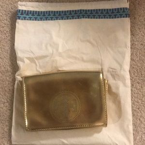 Gold Tory Burch clutch in good condition.
